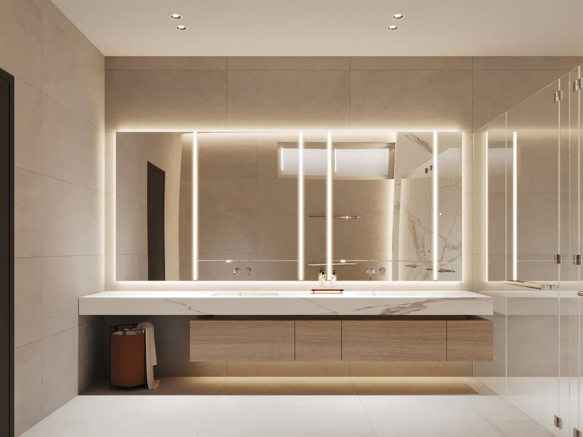 Modern bathroom with a large mirror, illuminated by LED lights, a white marble countertop, and a wooden cabinet beneath. The bathroom has beige tiled walls and a glass shower enclosure on the right.