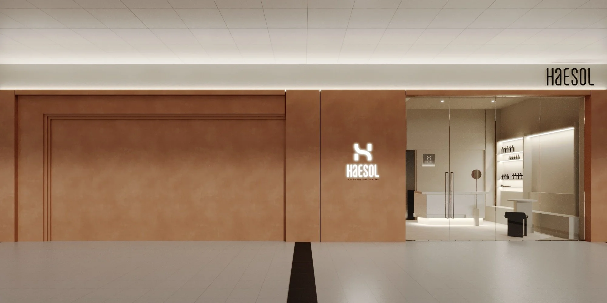 Modern storefront with a wooden exterior, illuminated white logo for HAESOL, and glass doors revealing a sleek interior with shelves of bottles and seating.