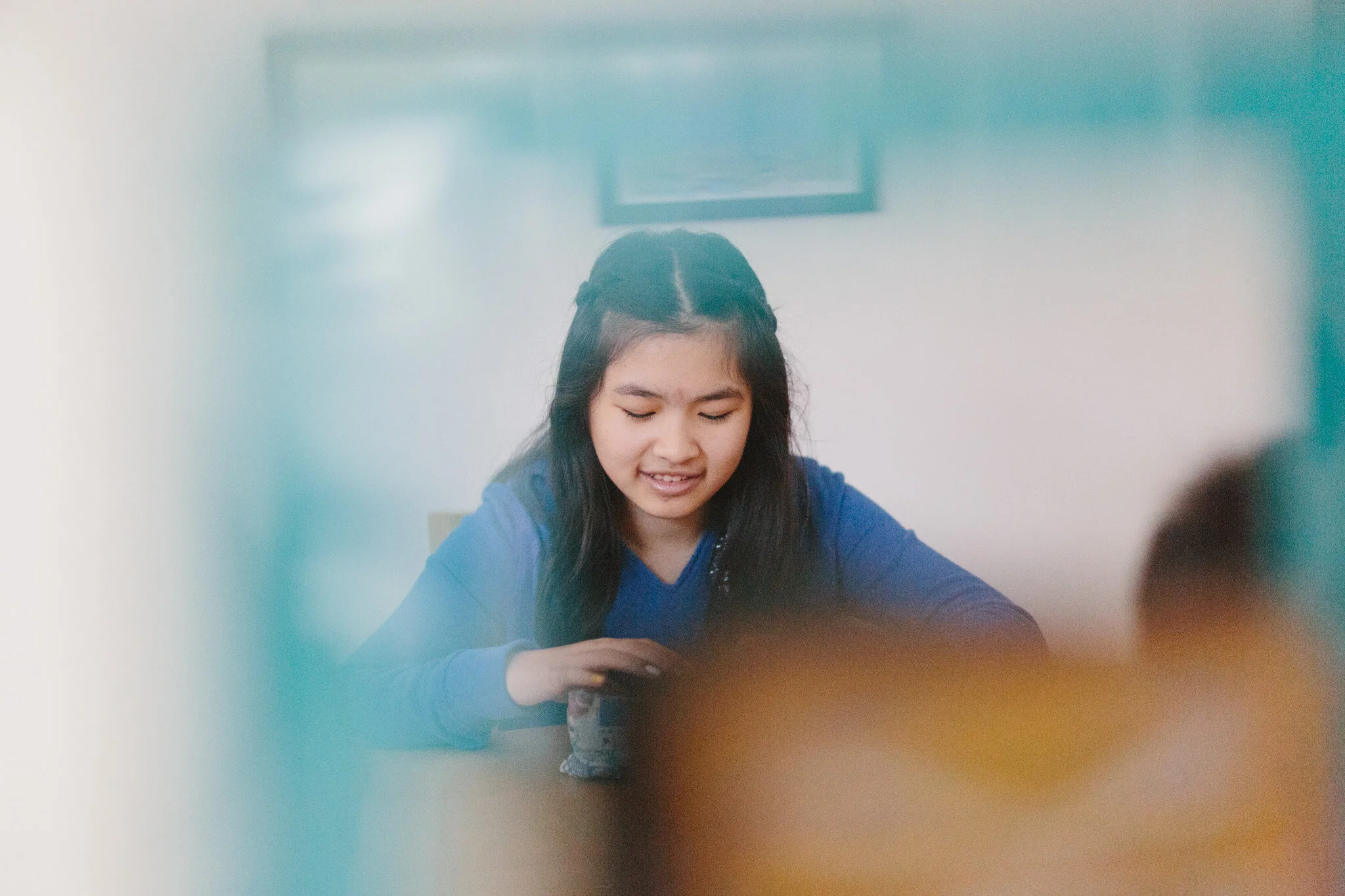 A teenage girl entranced in her book as part of a creative writing program for kids at the Creative Write-it studio in Melbourne.
