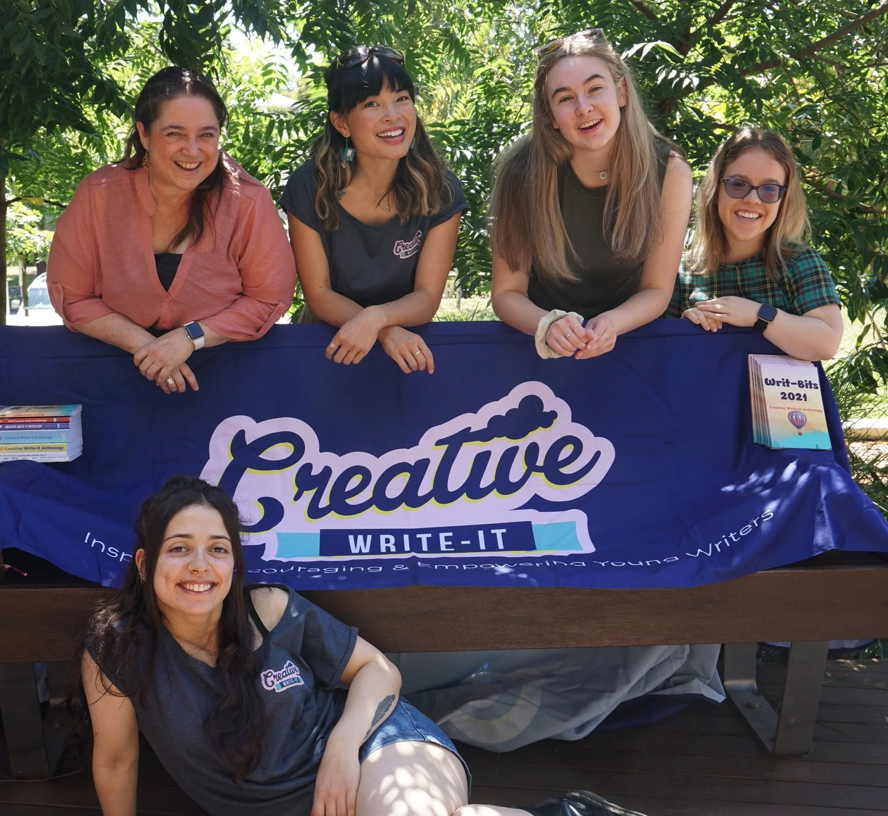 The Five Creative Write-it mentors smiling at the camera , excited to teach kids about creative writing.