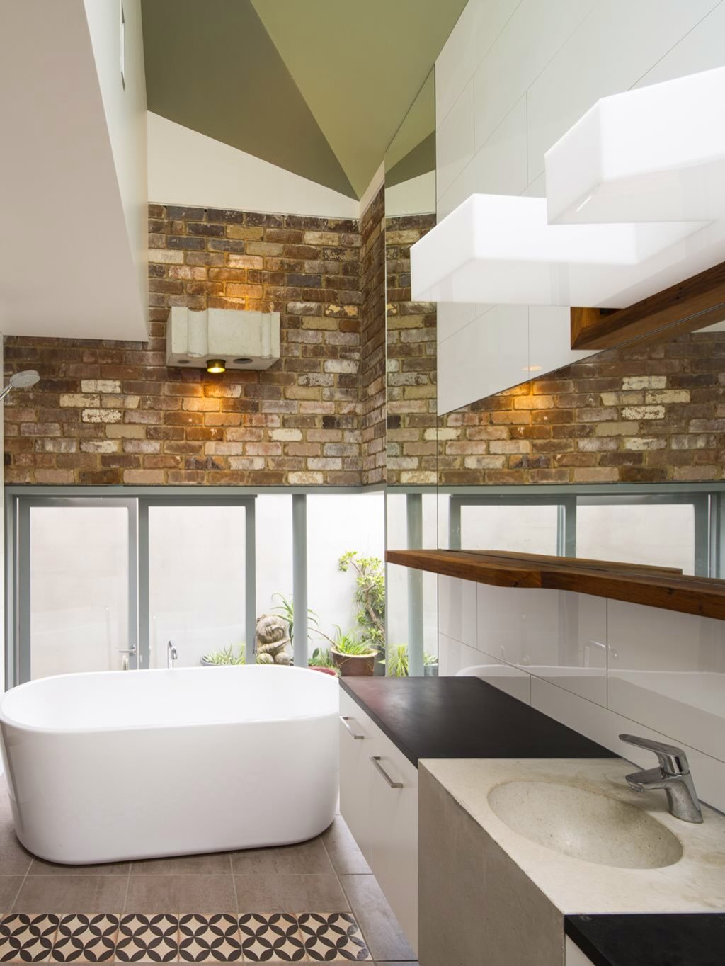 A flashback to a great project by @drewheatharchitect using Paperock SOLID in the bathroom &amp; kitchen. A great example of how black can be an anchor for the warmth of natural materials like wood and reclaimed bricks.
Photography: @brettboardmanpho