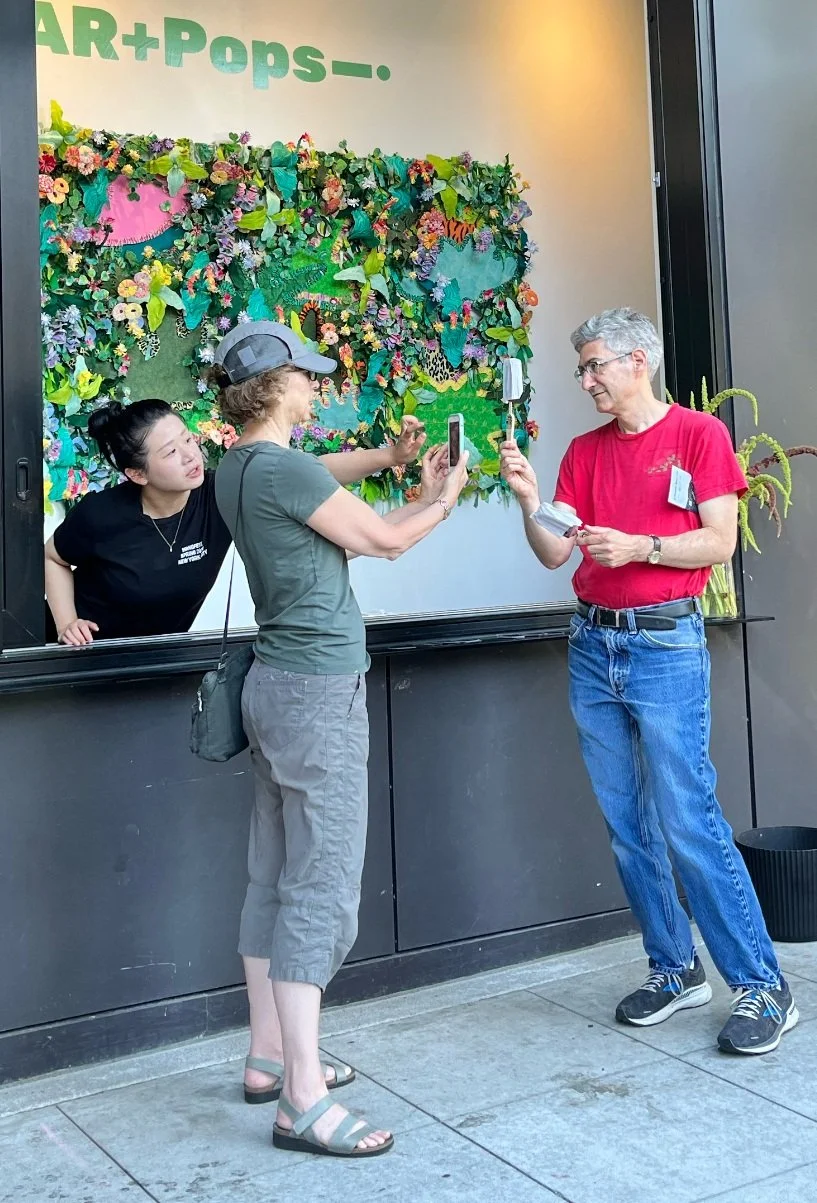 two people capturing their AR image from a Popsicle