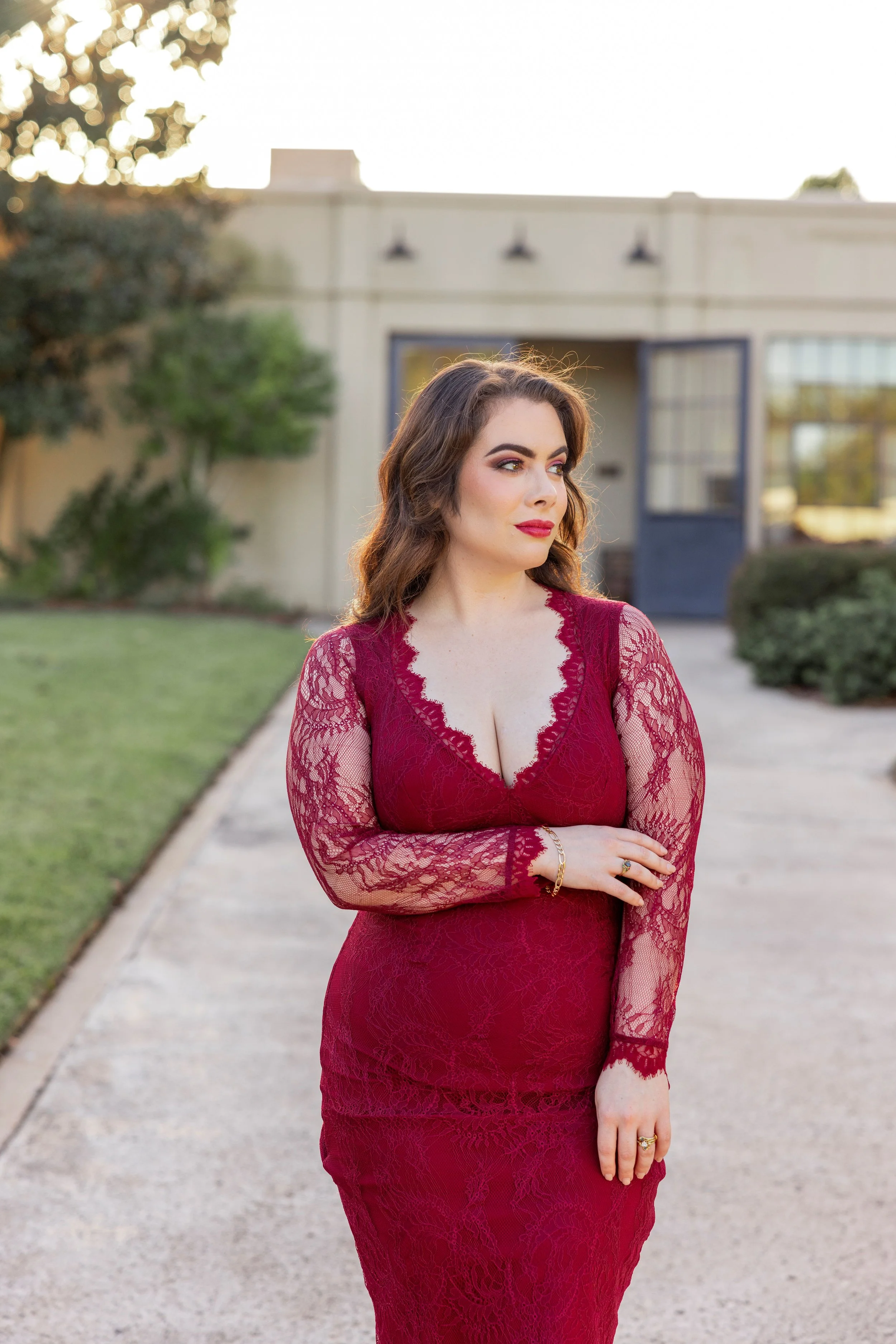 Nychelle  Schneider in a red dress looking towards her left.