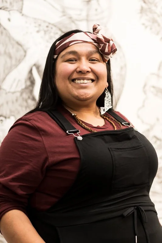 Lu smiling wearing accents of maroon