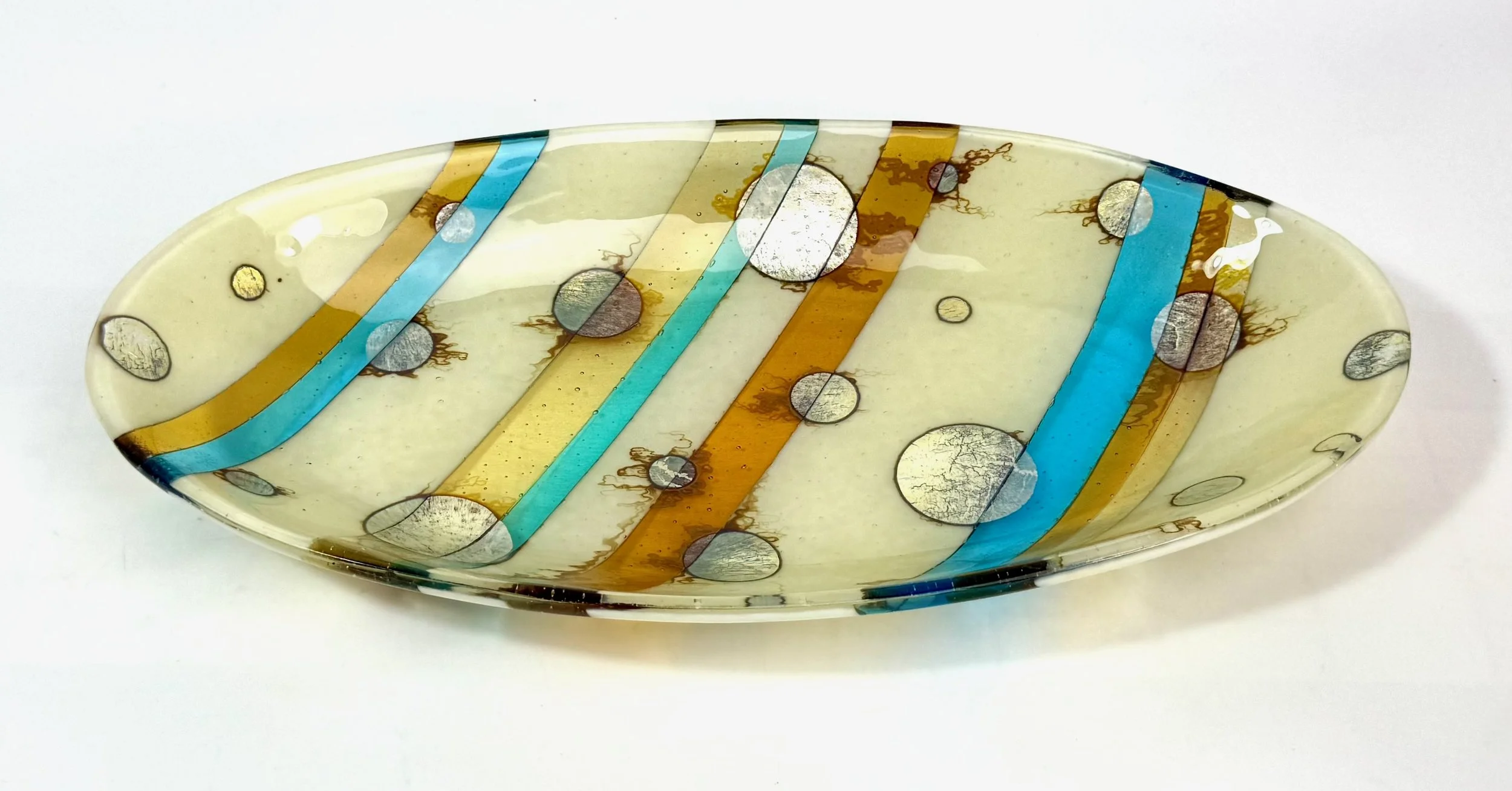 Fuming Moons by Roz Speirs
18 x 4.5 x 35 cm
Image 2 of 2
For Sale: $345 - Contact Roz directly on roz@clarityglass.co.nz.
I had fun creating smoke and mirrors, combining the precision of the glass strips and placement of the silver 'moons' with the u