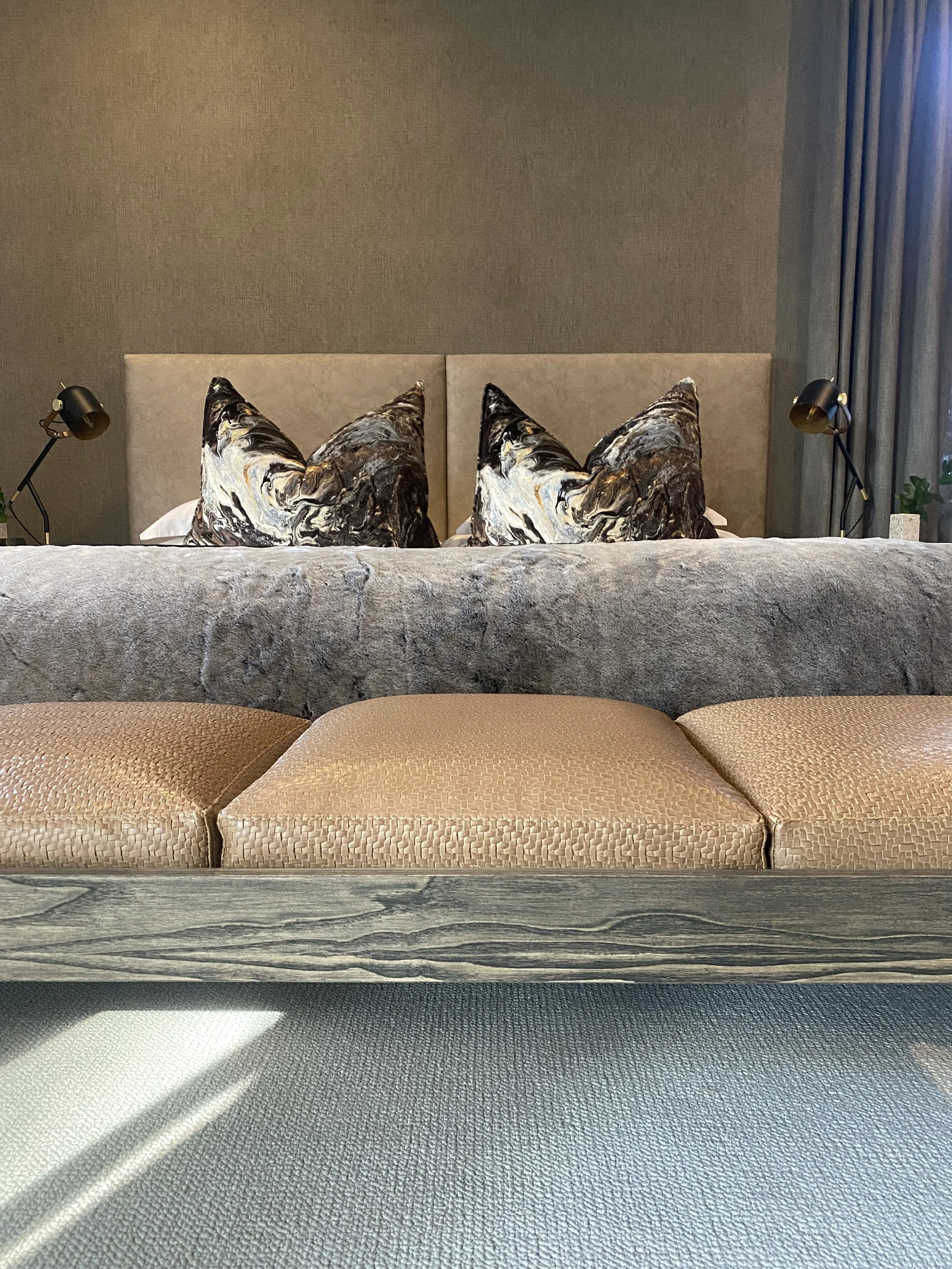 Headboard in Evo by FibreGuard Pro. Drapery in Motion by Fabric Library Wide. Wallcoverings in Tela by Arte. Scatters in Outerspace by Carlucci. Bed end in Matara Tessere by Designers Guild.