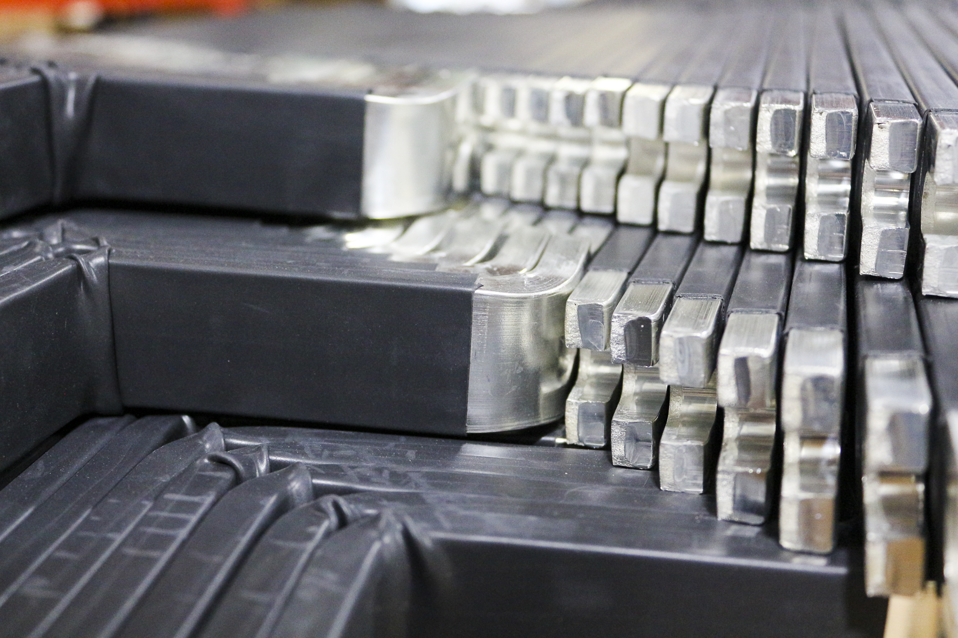 Close-up of metal stamps and black rubber stamping blocks on a workbench.