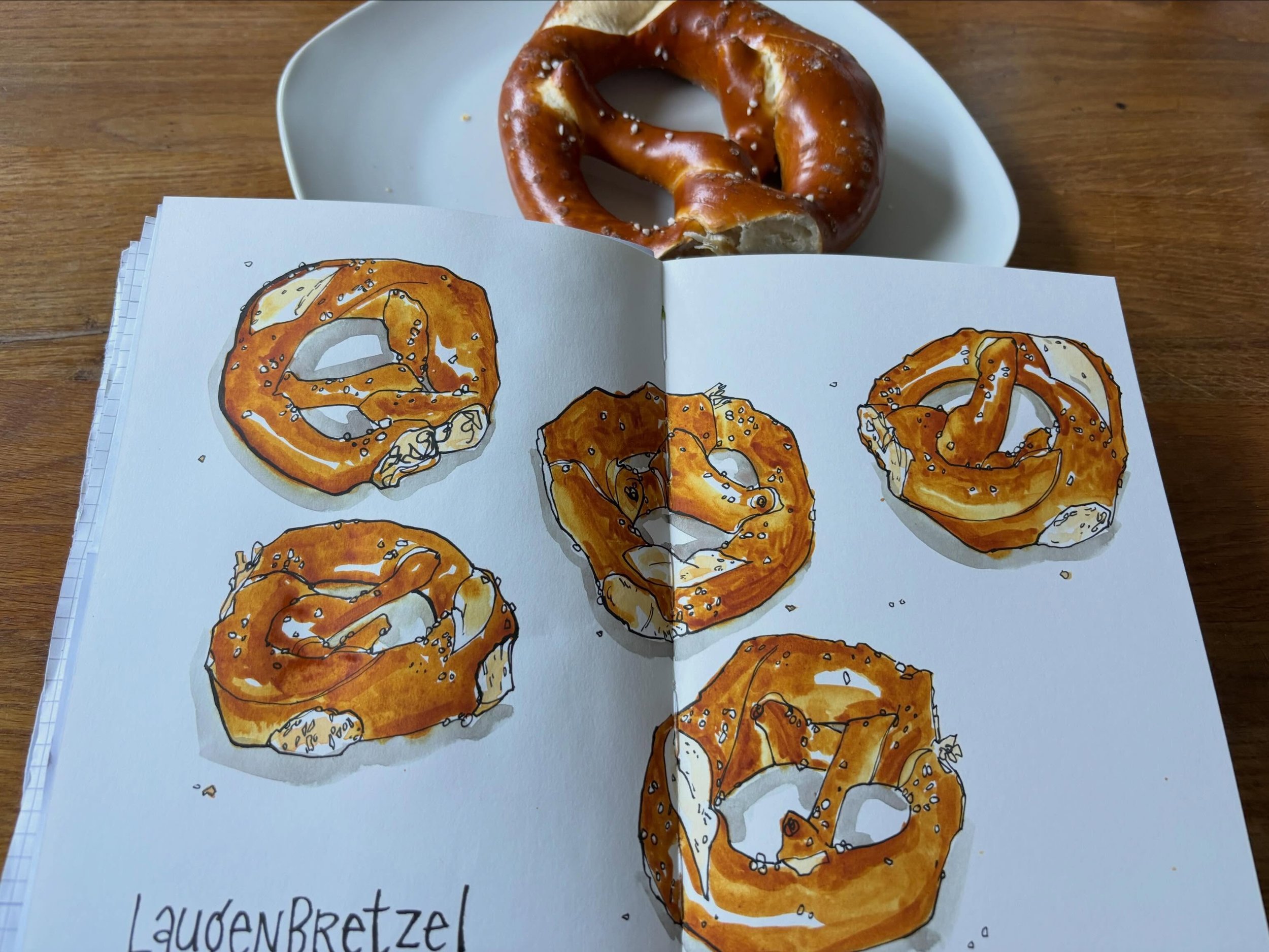German Laugenbrezeln (pretzels)! 
I absolutely love them. Not just to draw! 
They are found in every bakery in Germany, year-round. Pretty much like croissants in France. 
What makes these soft, chewy bretzels authentic is not just the shape but also
