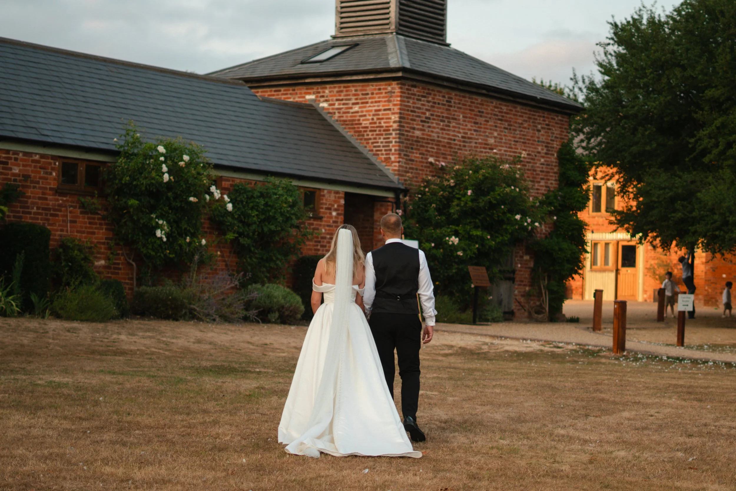 bride and groom walking at apton hall essex