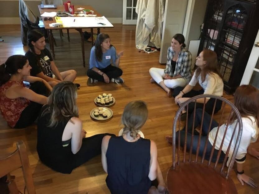 women on the floor talking