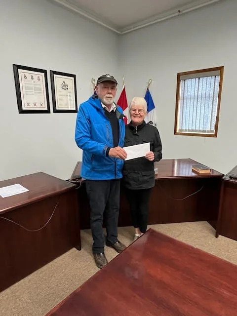 Port Edward District's Knut Bjorndal giving Hospice's VP Susan Crowley a donation for Hike for Hospice 2024