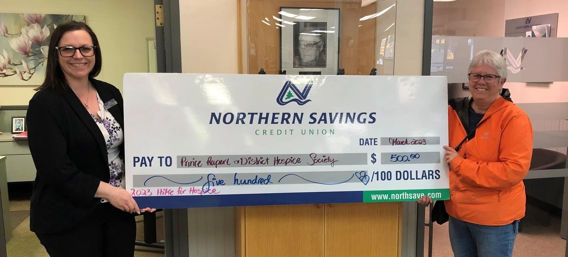 Board Treasurer Joanne Donohoe receiving a Hike for Hospice donation from Northern Savings Credit Union
