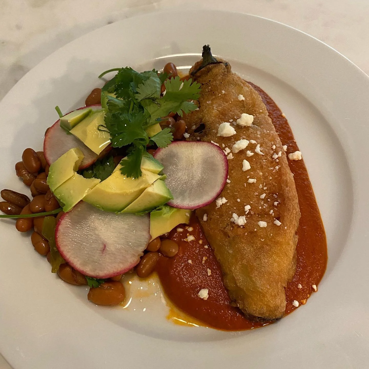 Made #chilerelleno for the first time. We thought it was amazing! Pintos with aromatics, avocado, radish and cilantro. #hatchchile with Queso Oaxaca and a California chili sauce. #bonappetit