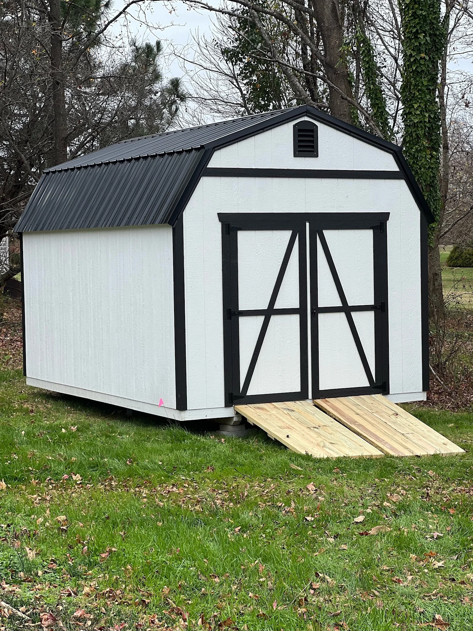 alpine shed white with black trim and ramp.jpeg