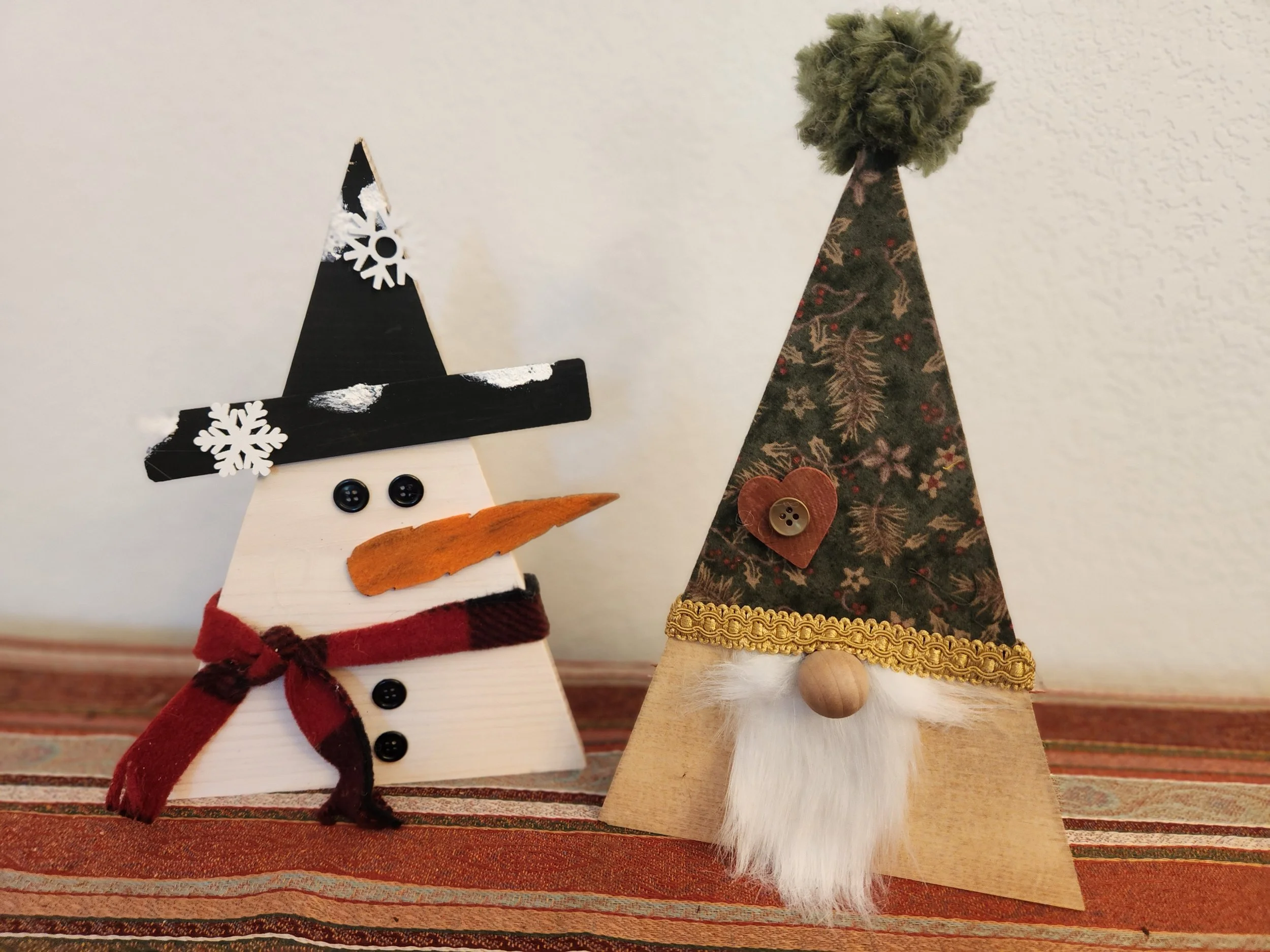 Stacked wooden blocks with holiday decorations and the words "Joy to the World" written on them.