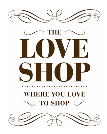 Decorative sign with text 'The Love Shop' and the tagline 'Where you love to shop' in brown font with ornate swirl designs.