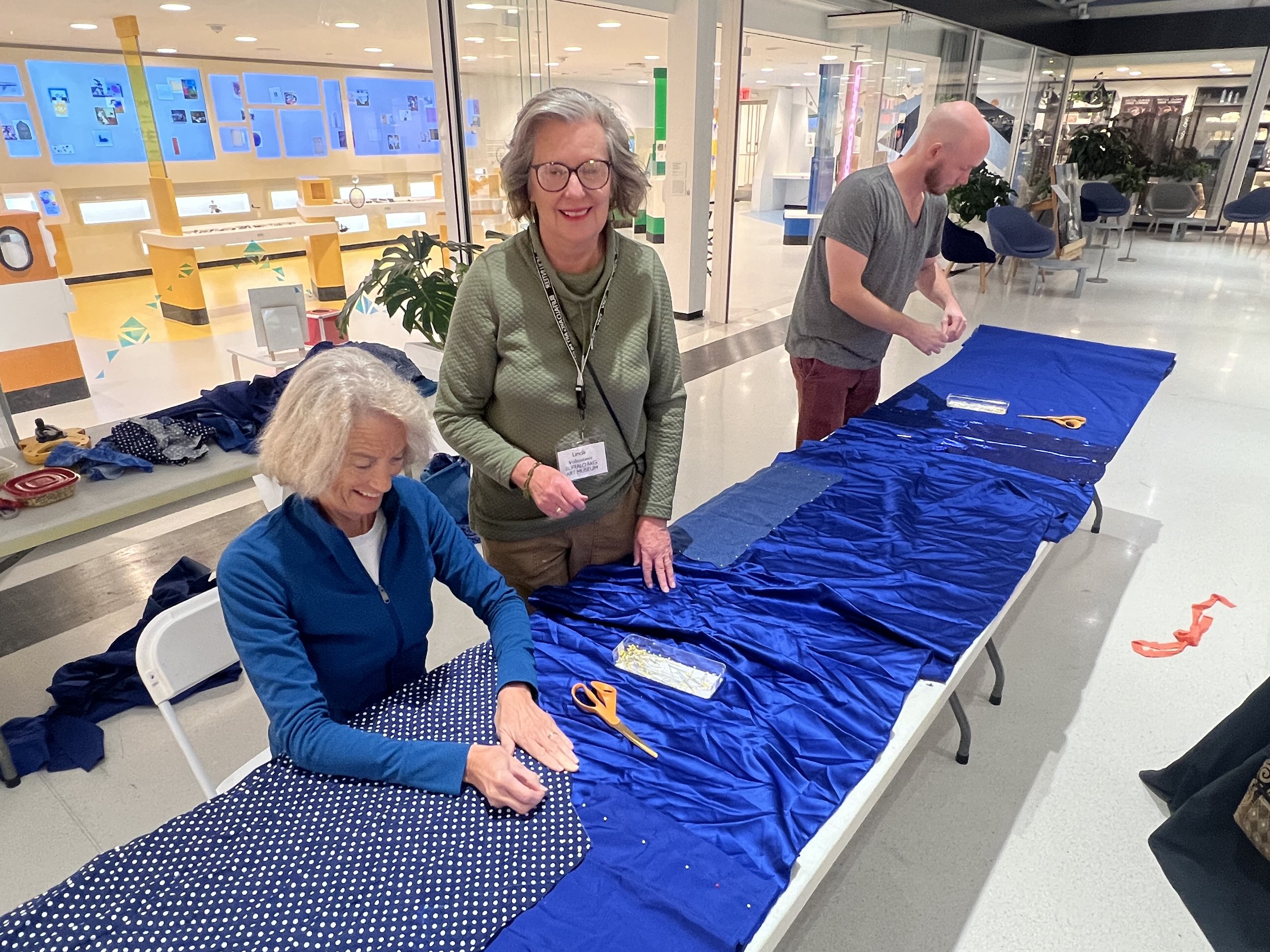 Public Sewing Days for Night Rainbow (2025) - Amanda Browder: Located at the Buffalo Art Museum AKG: part of the AKPublic Art Initiative exhibition Hi-Vis. All fabric is donated and built with the support and labor of the citizens of Buffalo, NY.