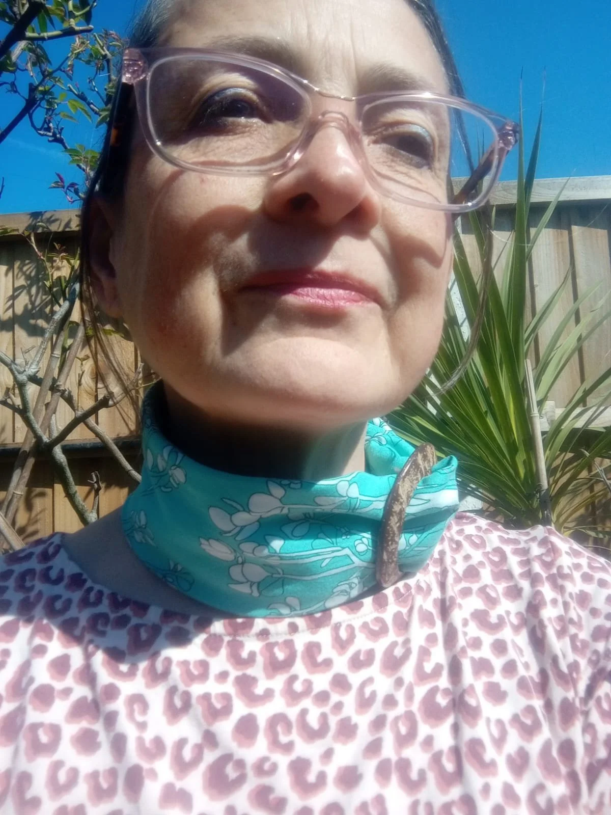 Wearing a coconut scarf ring and tucking the edges of the scarf in around the neck