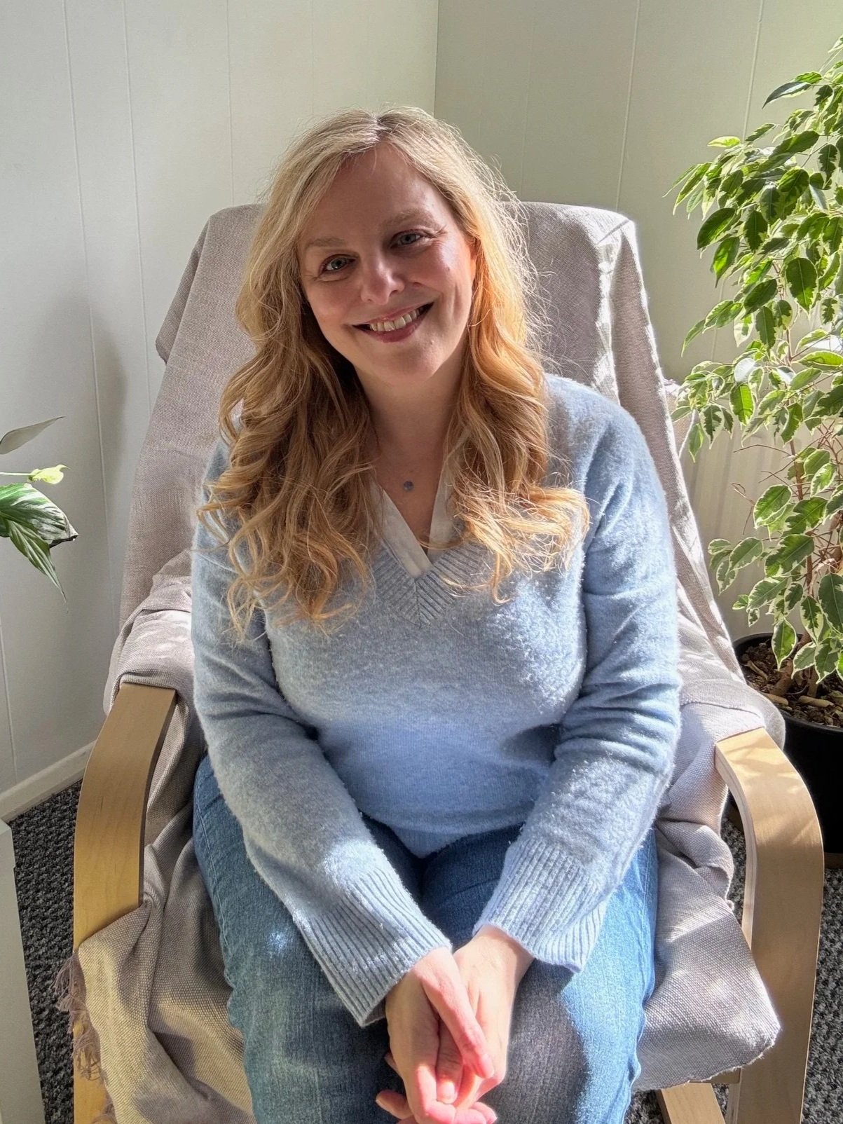 Inside Sarah Pritchard's somatic therapy space in Shrewsbury, a calm and light space with plants and ergonomic seating for 1:1 sessions.