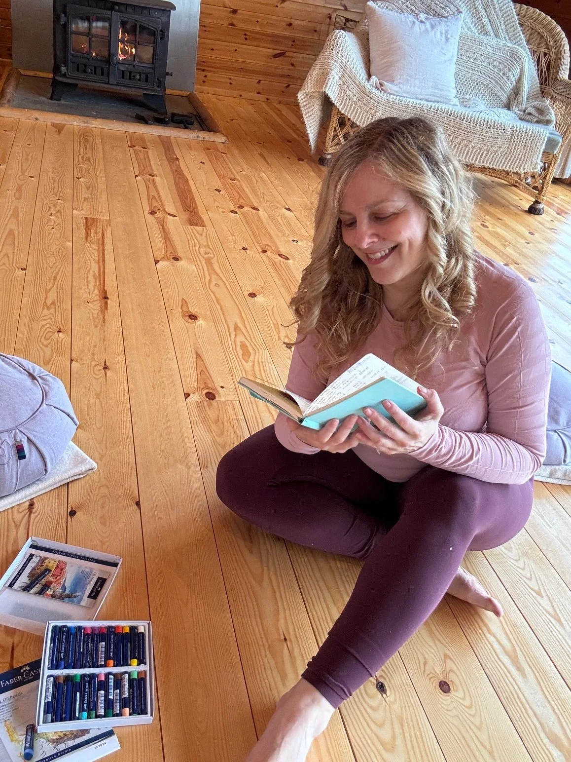 Sarah Pritchard, a Registered Master Somatic Movement Therapist, facilitating an expressive arts process at a somatic retreat in Shrewsbury. Sarah is seen journaling and using oil pastels to support nervous system regulation and emotional integration