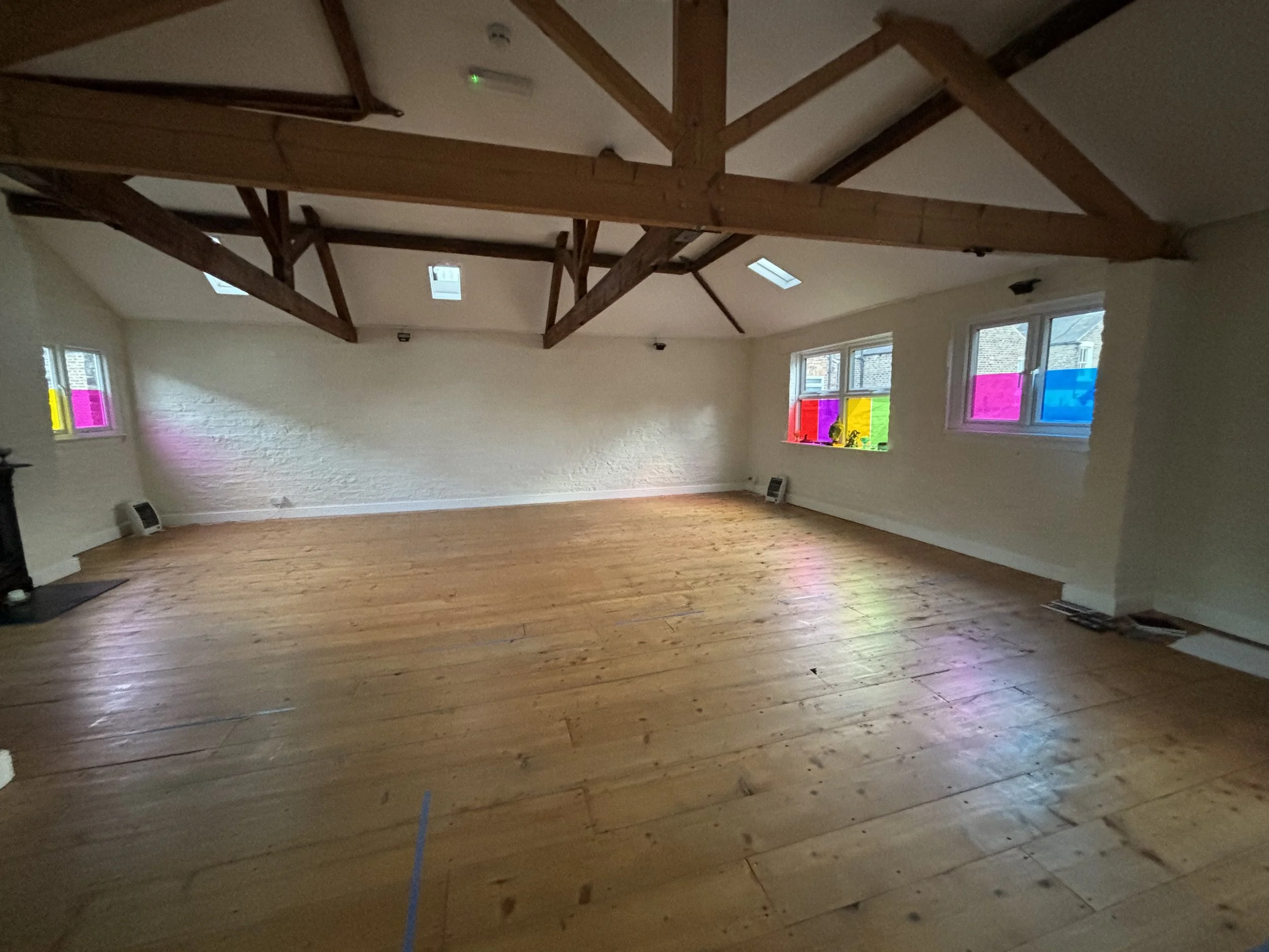 Light-filled beamed studio at The Stables Yoga Centre in York, fully equipped for Sarah Pritchard's Franklin Method embodied somatic movement workshop.