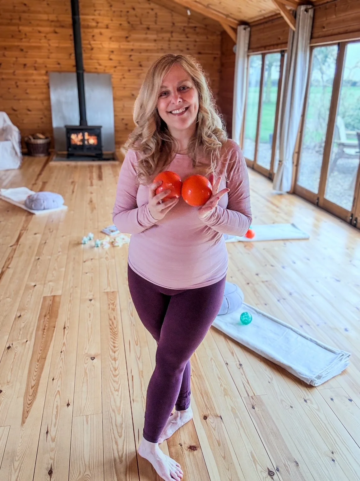 Sarah Pritchard, Level 4 Franklin Method Educator, Buff Bones Faculty, holding orange Franklin balls in her clinical somatic space. Specialist Pilates & Somatic Movement Therapy for pilates teachers and clients in Shrewsbury & across the UK.