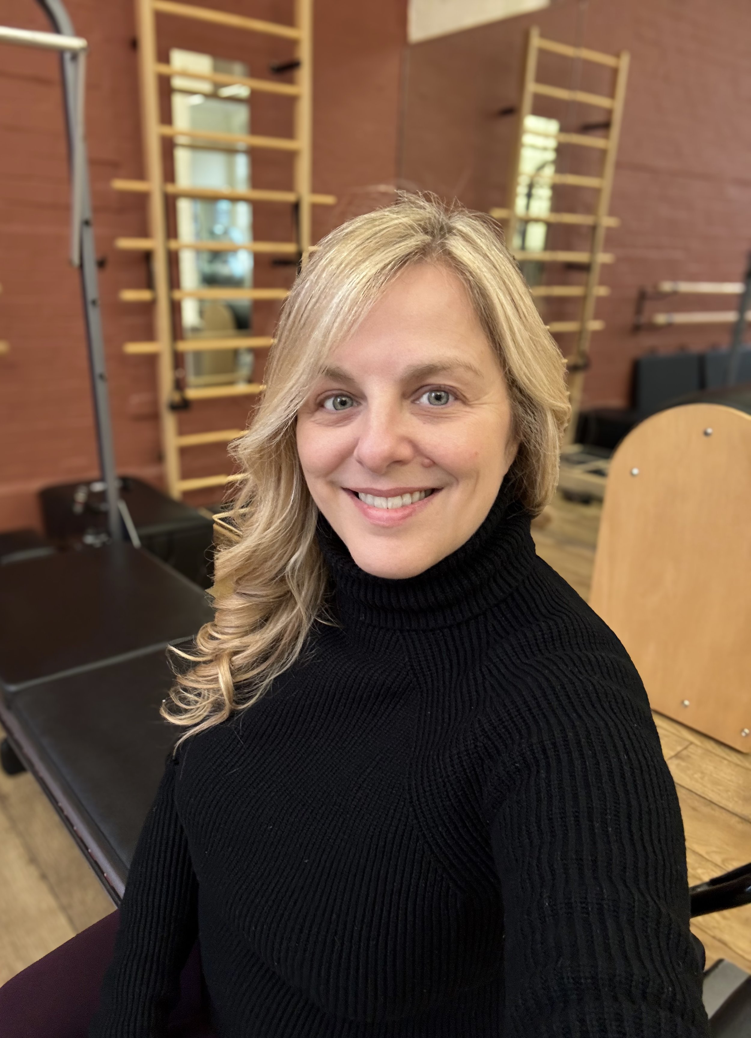 Sarah Pritchard, ISMETA registered Somatic Movement Educator and Pilates specialist, in a professional studio setting in Birmingham.