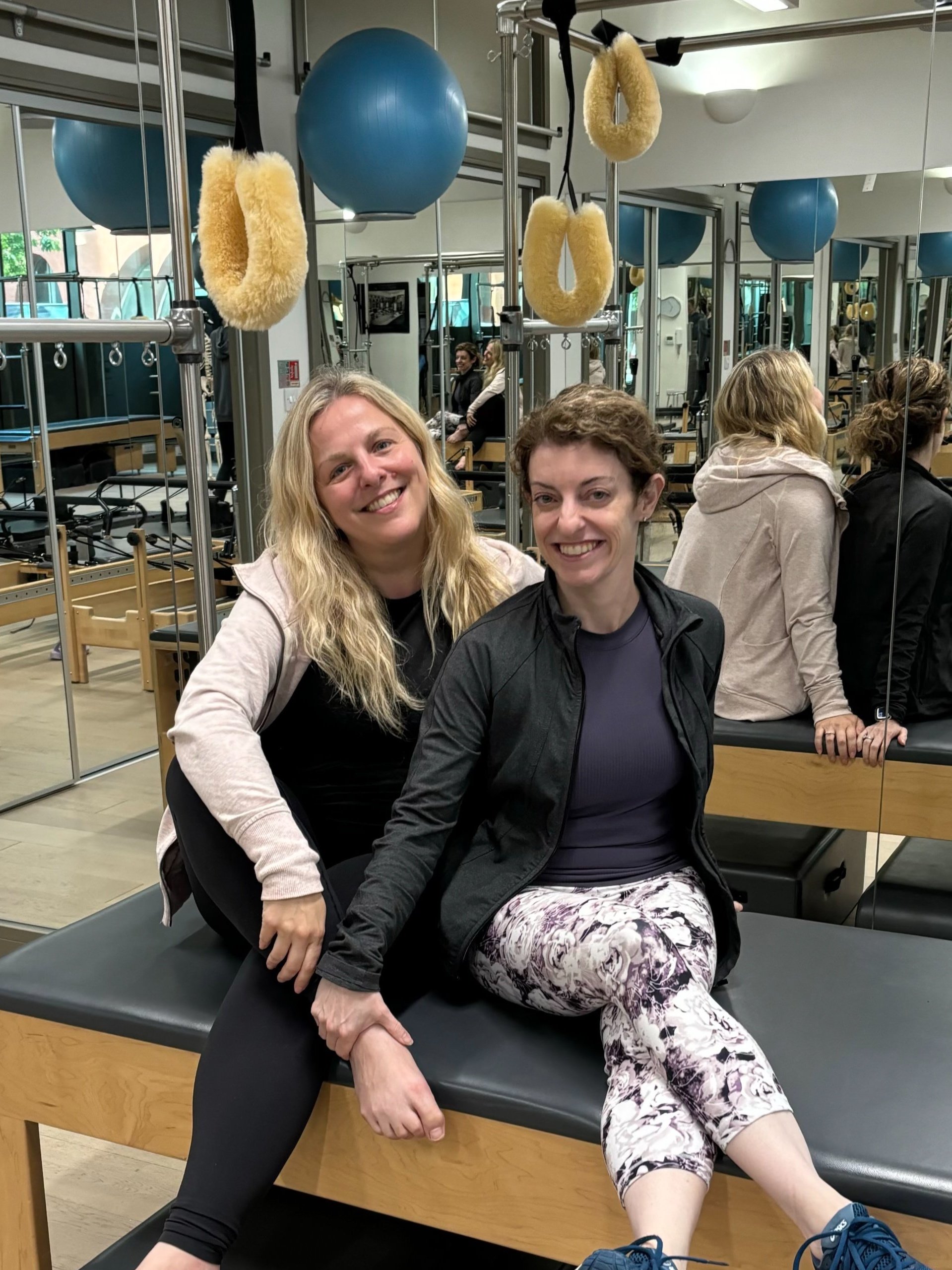 Buff Bones UK Faculty Sarah Pritchard with founder Rebekah Rotstein at Polestar Pilates UK training of the Buff Bones instructors sitting in their pilates studio