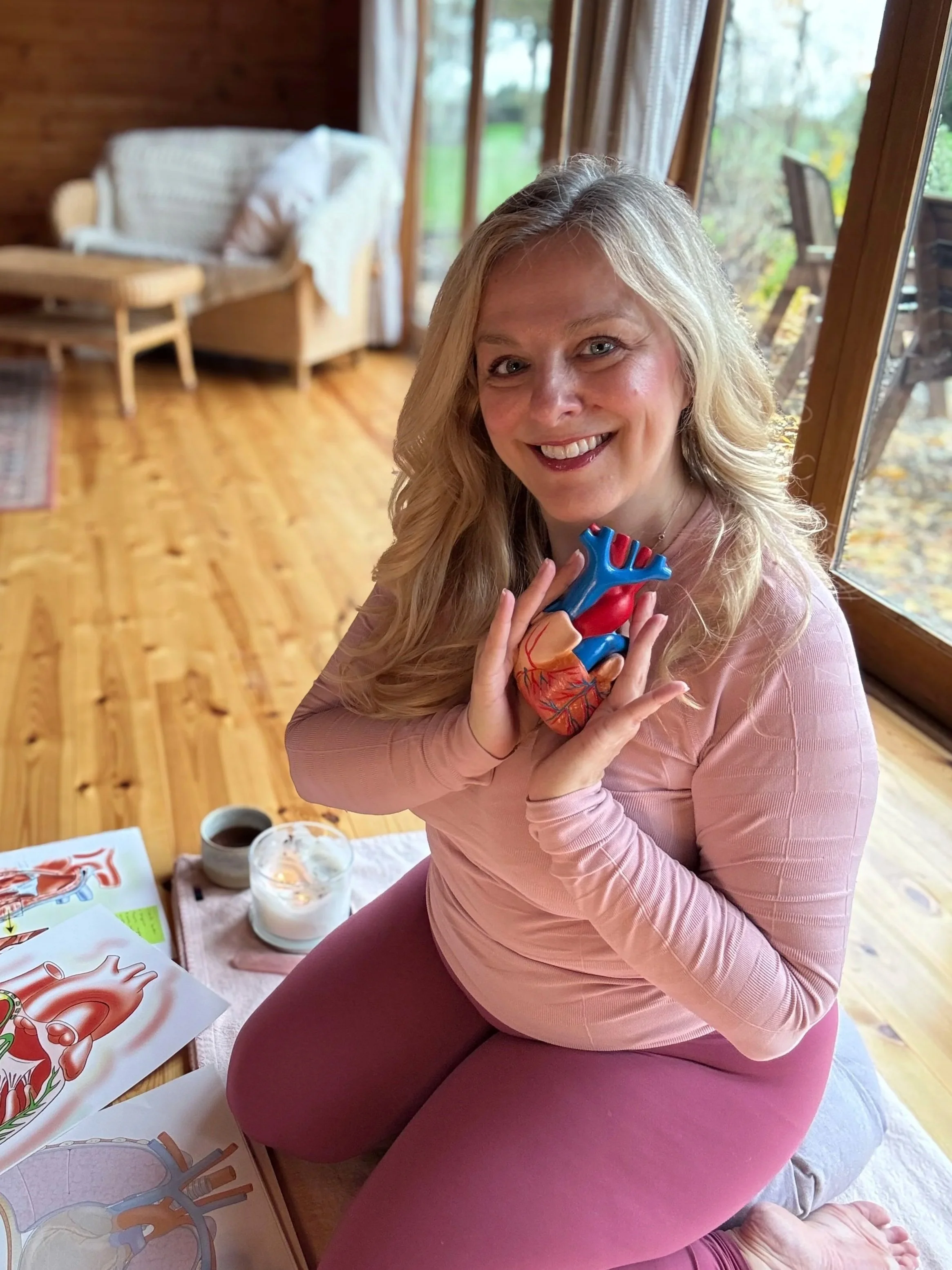 Level 4 Franklin Method Educator Sarah teaching heart-centered postural alignment with anatomical heart model.