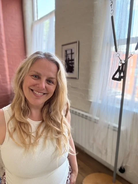 Sarah Pritchard in the light filled Cool Pilates studio Birmingham by the ped o pull, the studio has the full range of equipment for pilates sessions for female health
