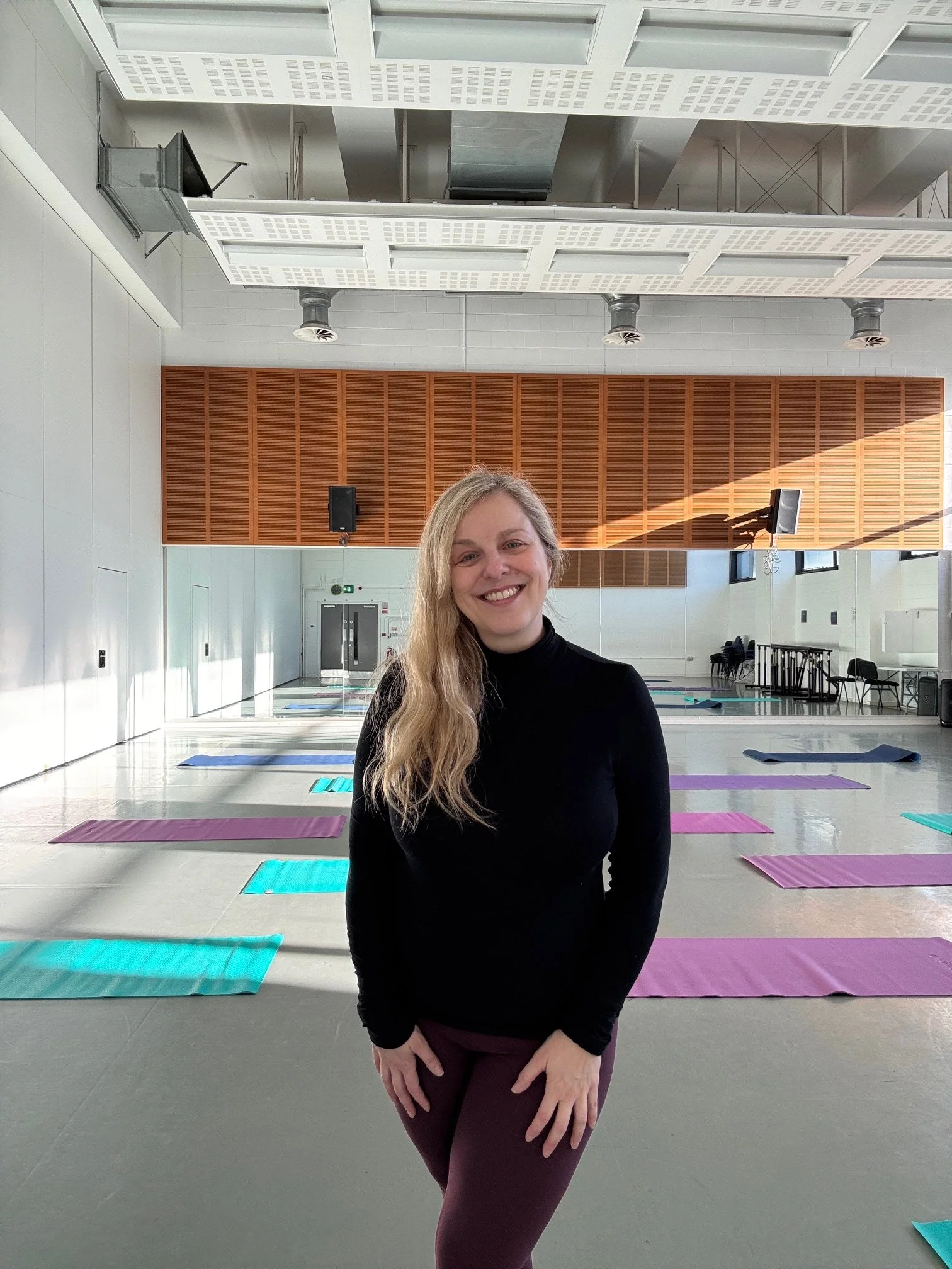 Sarah Pritchard, a Level 4 Franklin Method Educator and Pilates Tutor, smiling in a bright studio at FABRIC, the venue for the Centre for Advanced Training (CAT) in Birmingham.