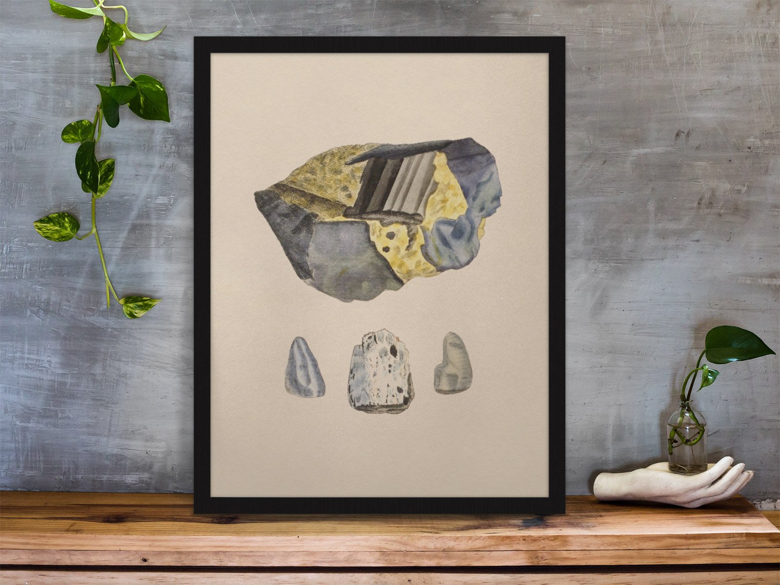 framed-art-print-standing-on-a-wooden-desk-against-a-concrete-wall-near-a-hand-decoration-a10403 (3).jpeg