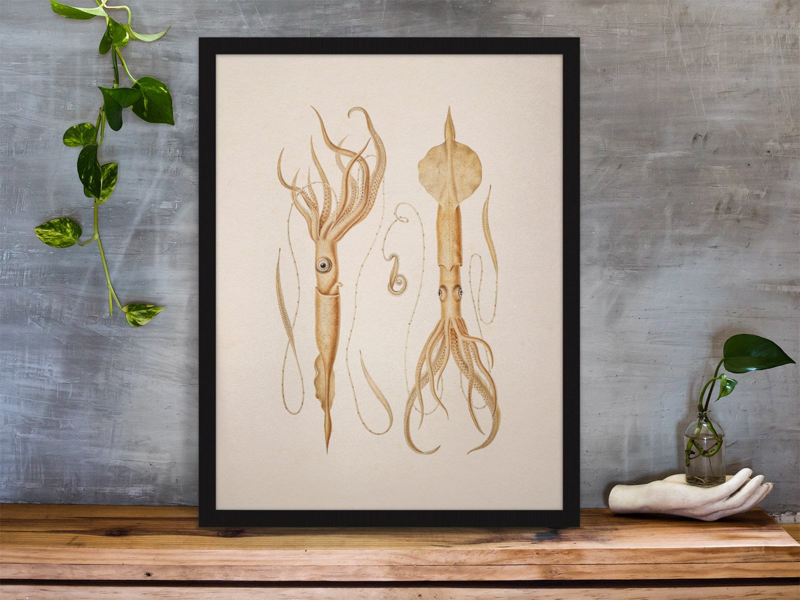 framed-art-print-standing-on-a-wooden-desk-against-a-concrete-wall-near-a-hand-decoration-a10403 (4).jpeg
