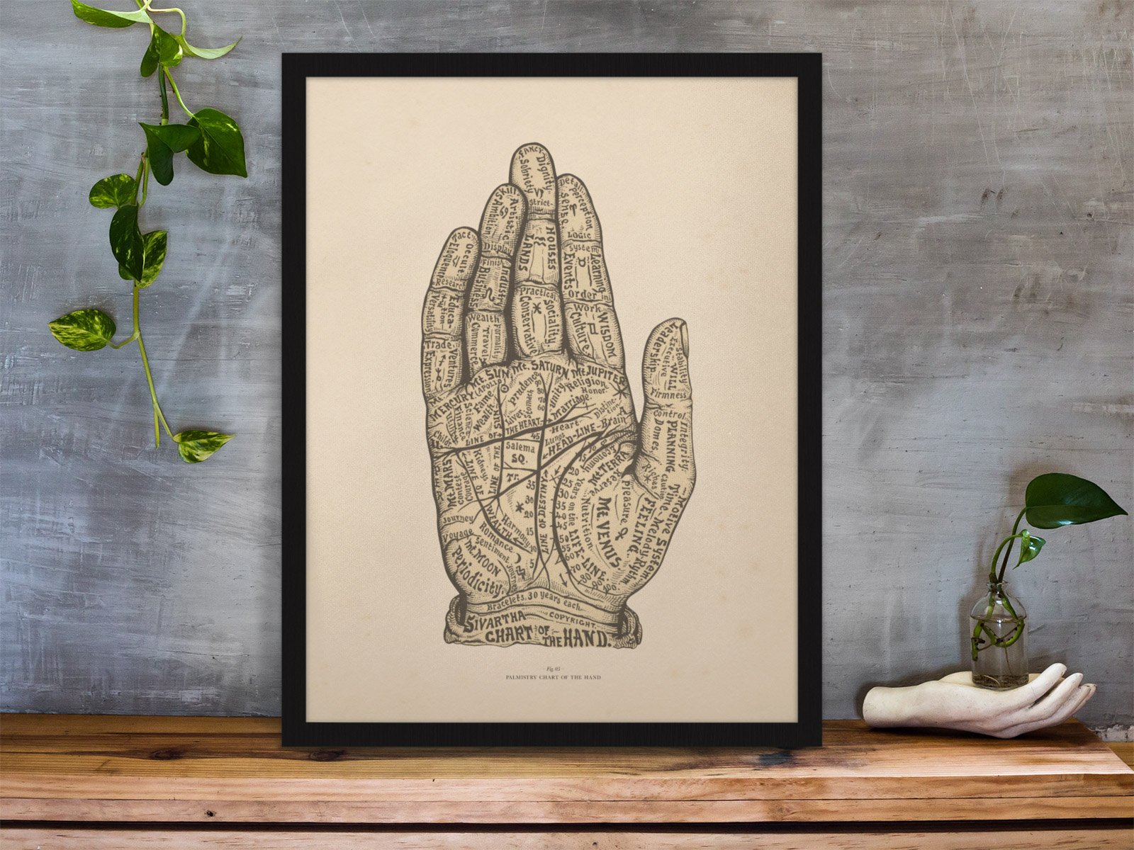 framed-art-print-standing-on-a-wooden-desk-against-a-concrete-wall-near-a-hand-decoration-a10403 (5).jpeg