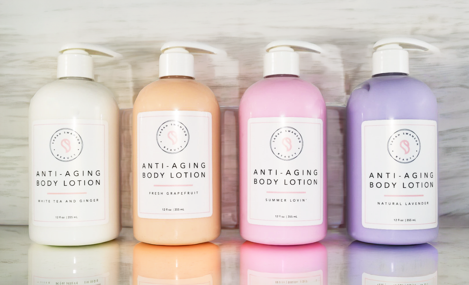 Four colorful anti aging body lotion bottles in bathroom