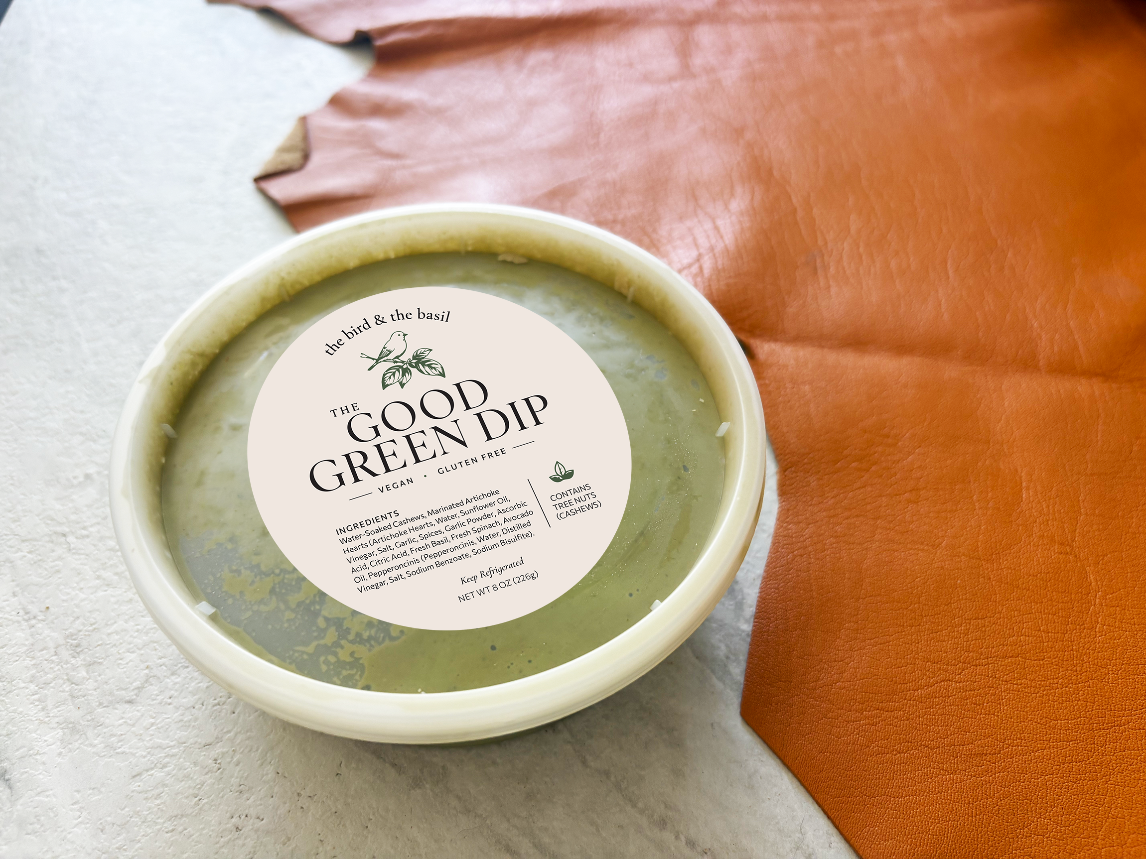 The Good Green Dip on white table with tan leather
