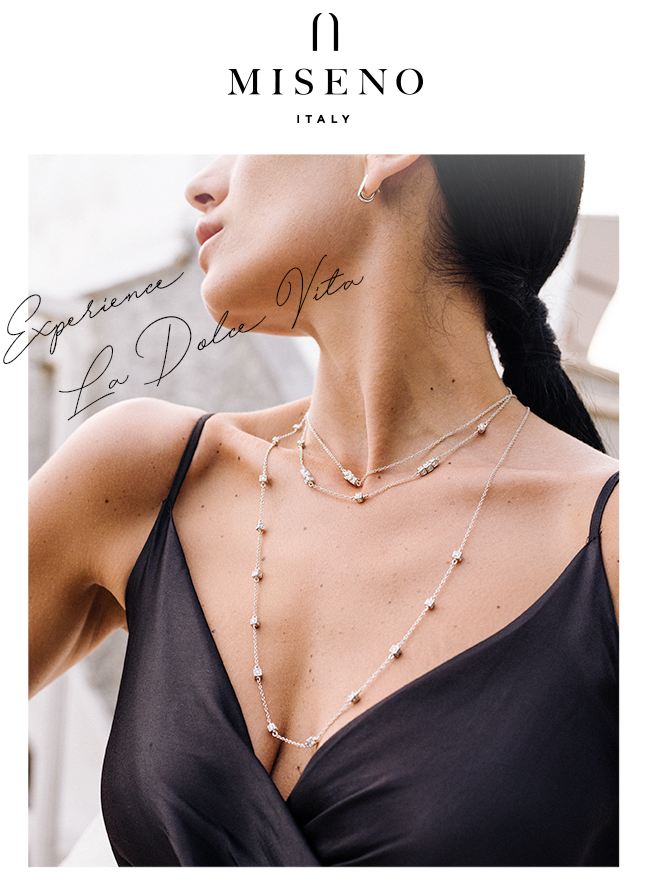 Woman with head turned wearing black dress and a layered diamond necklace with words "Experience La Dolce Vita" in script overlaid