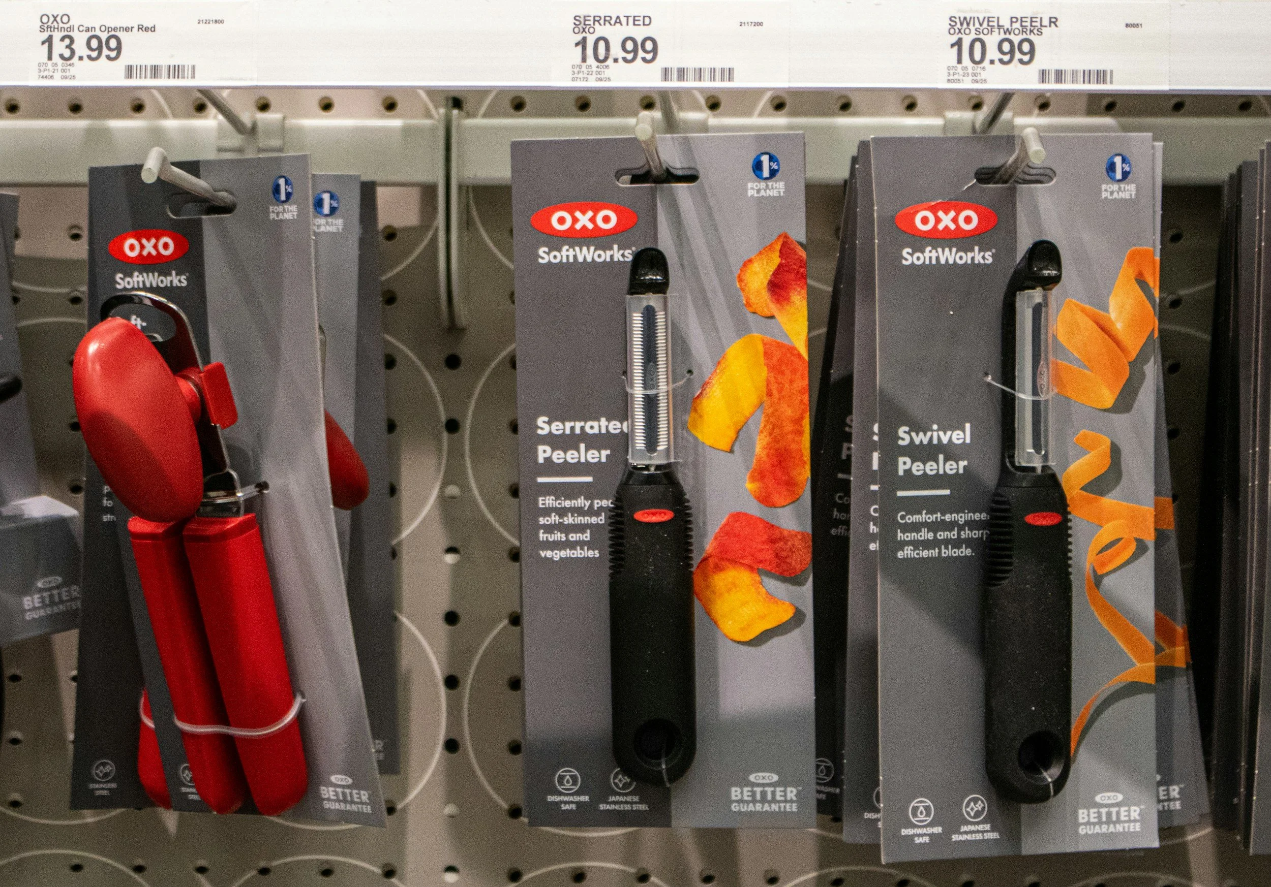Oxo peelers hanging up on a shelf in a store