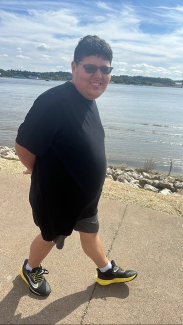 A teen walking along the river