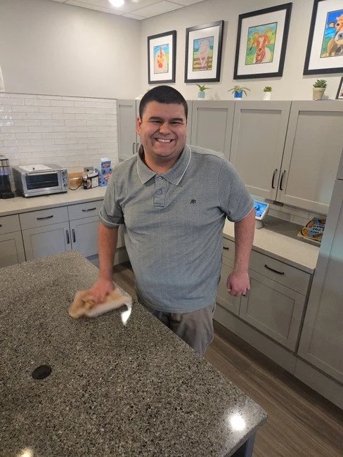 A teen cleaning the kitchen