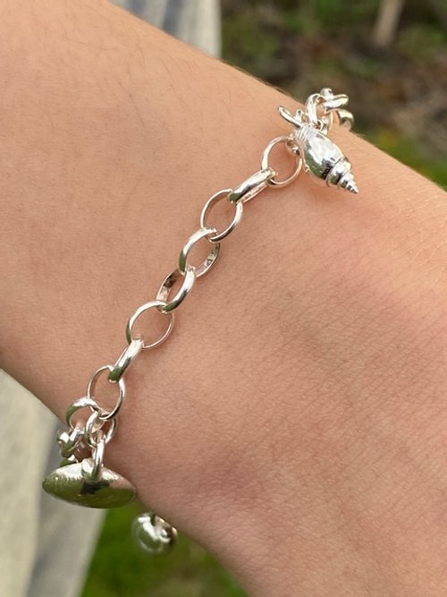 Rose Honey silver shell charm bracelet worn.jpeg