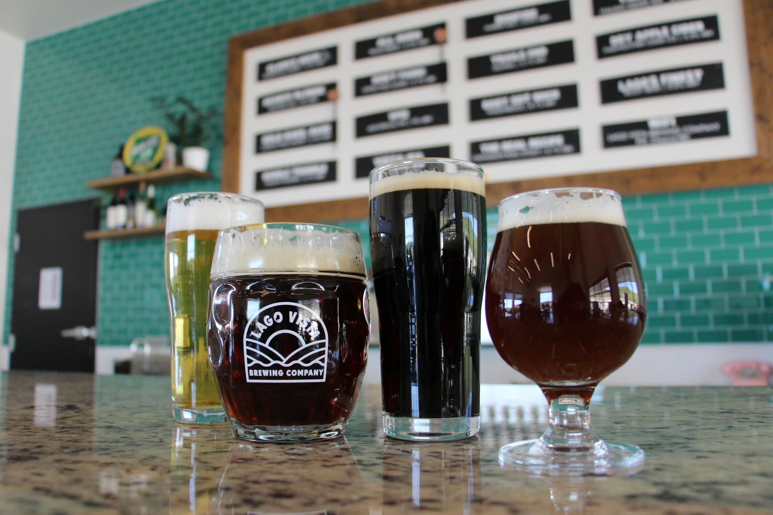 Four Lago Vista Brewing Co Beers Lined up - light lagers and dark beer