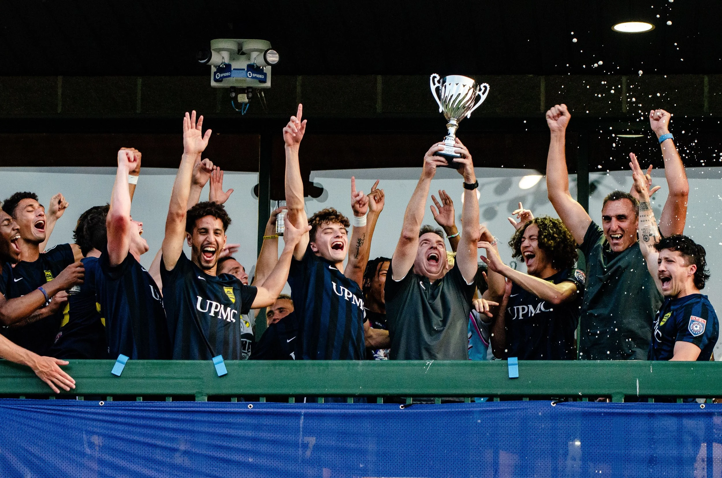 team holding trophy and cheering