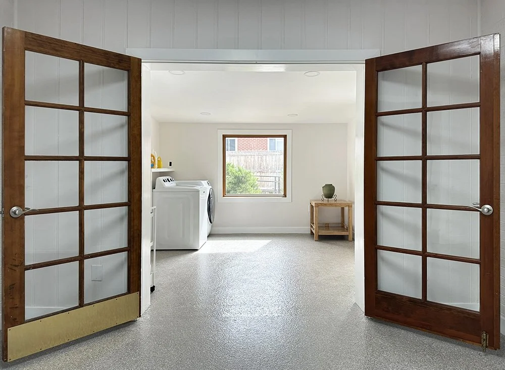 French doors at the far end of the breezeway lead to the laundry room.