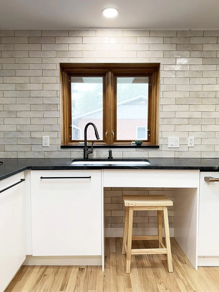 Counters are normal height, but roll-unders at the sink and cook top allow a power wheelchair with an elevator lift to use the space. Or enjoy sitting on a stool while washing dishes. 