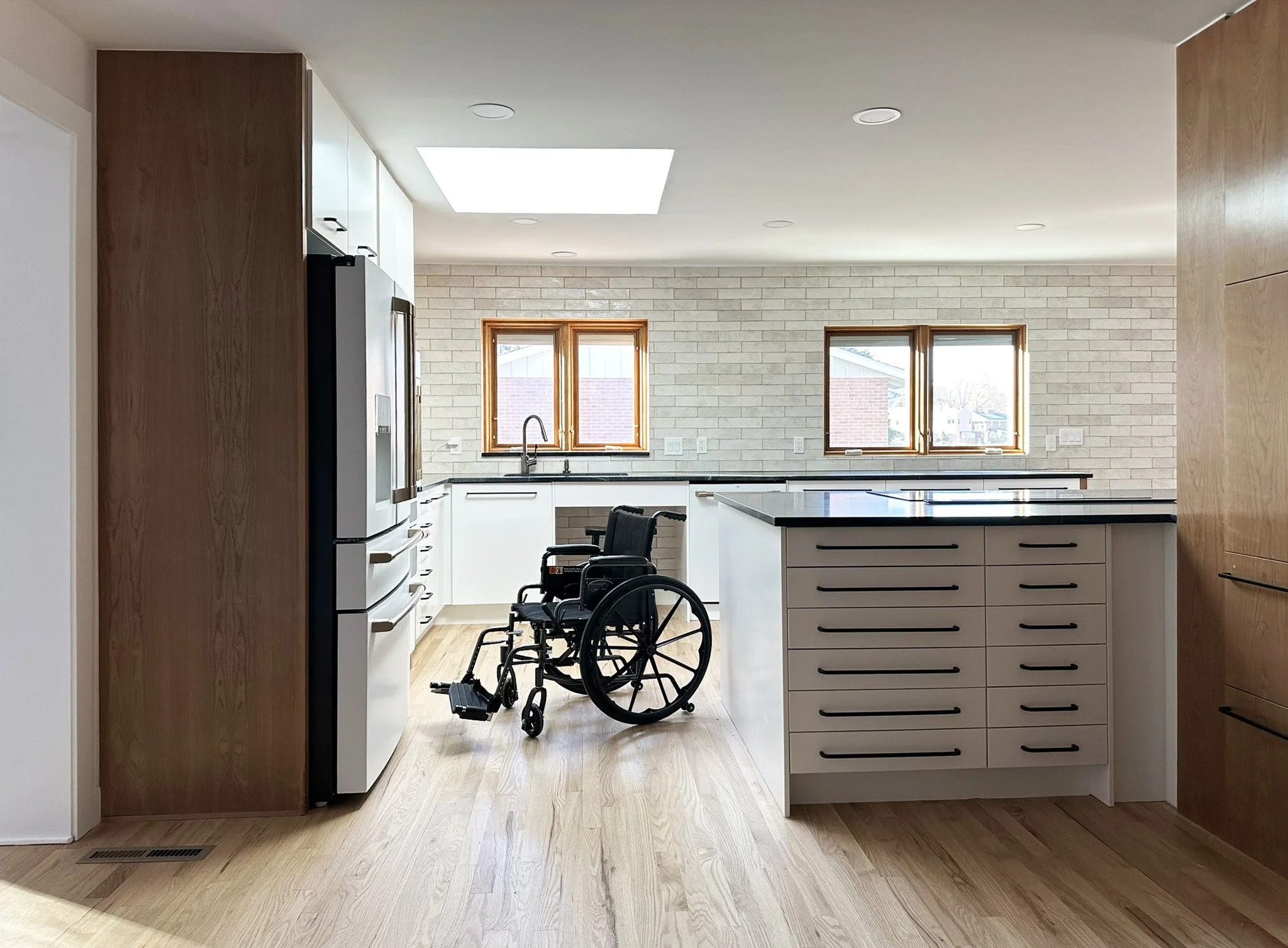 The kitchen connects the dining room to the living room.