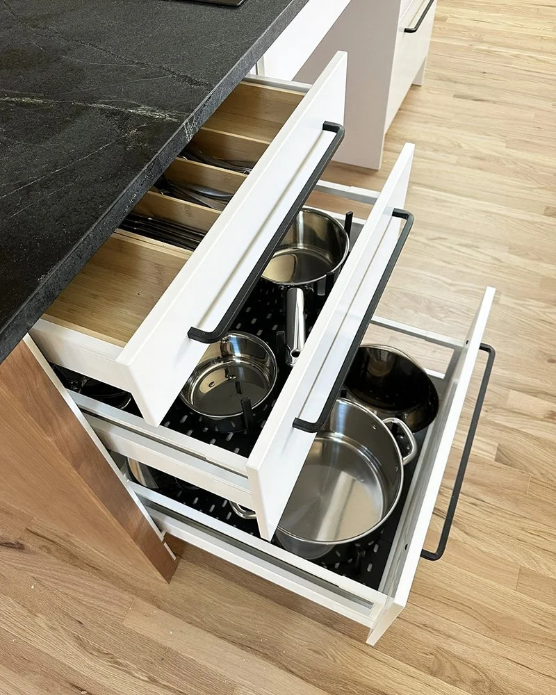 The drawers are equipped with compartments and grids for easy storage and access.