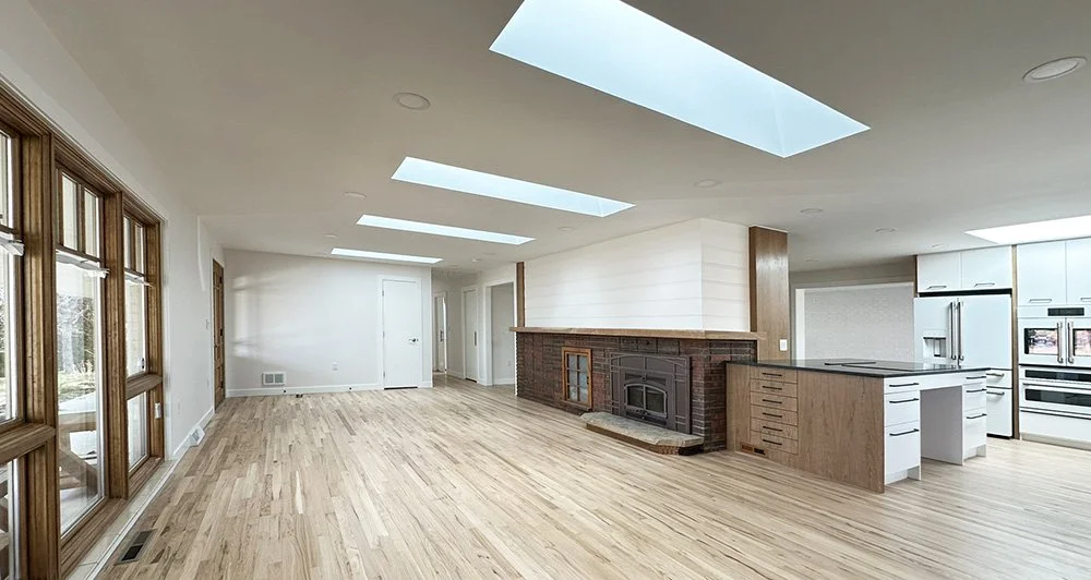 The living room, kitchen, and dining area are arranged around the central hearths.