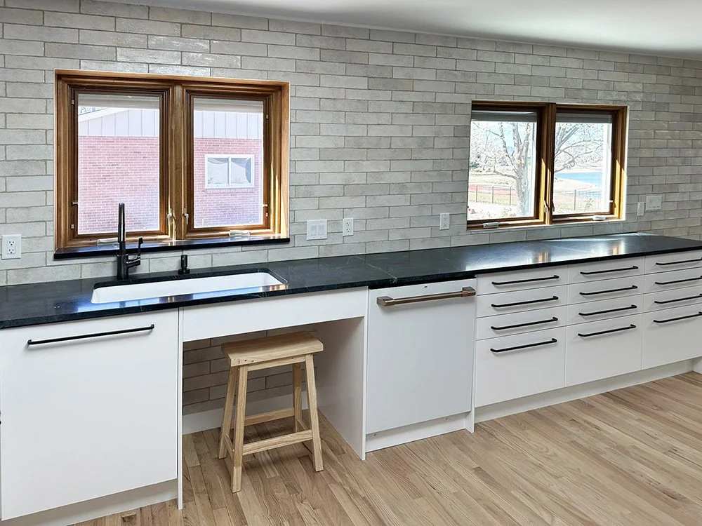 Most of the kitchen storage is in low drawers with large handles for ease of access. We kept the soft close drawers  24" wide or less so that they wouldn't be too heavy when full. 