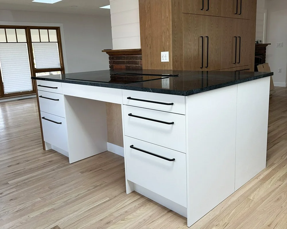 A roll-under space at the induction cook top on the island. 